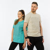 A female and a male wearing organic cotton t-shirts in teal and light brown colours with a geometric prints in the front