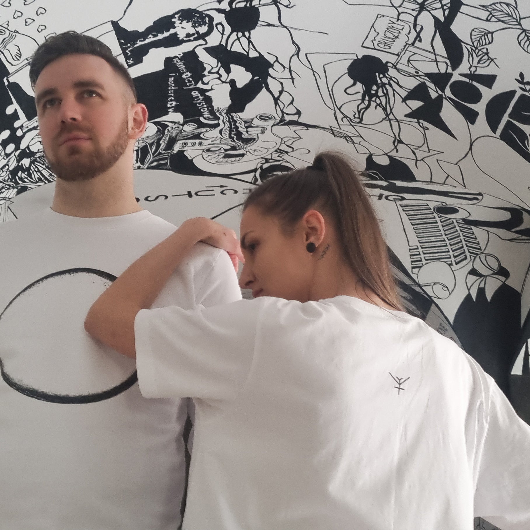 A male and female wearing white Yulunga brand organic cotton clothing