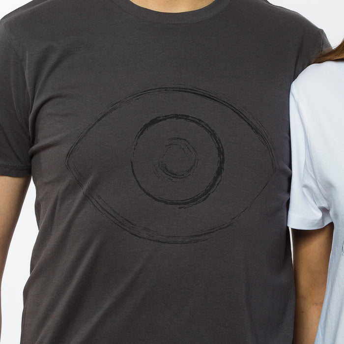 A grey t-shirt with an image of an eye in black ink in the front