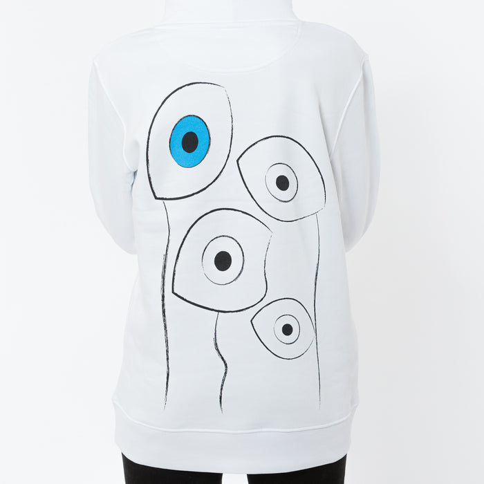 A white unisex hoodie with a large abstract image of hand painted eyes in black and white and one blue eye. The garment is made of organic cotton.