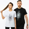 A female and a male wearing white and black t-shirts made of organic cotton with an abstract grungy print on the front.