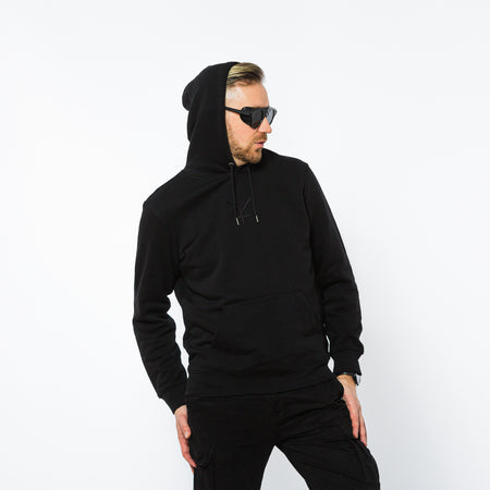 A male wearing a fully black organic cotton hooded sweatshirt with a black Yulunga brand logo embroidered on the chest