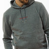 A male wearing an organic cotton grey hoodie with a red Yulunga brand logo embroidery on the chest