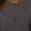 A close up on an ethical sweatshirt in lavender grey with a grey Yulunga brand logo embroidery