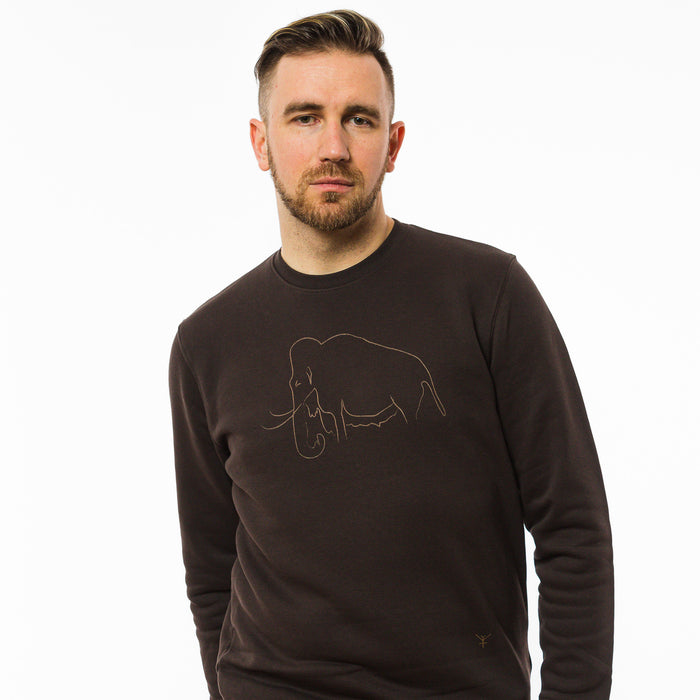 A male model wearing a unisex brown sweatshirt made of eco-friendly fabric with an image of a mammoth and a little Yulunga brand logo printed on the chest 