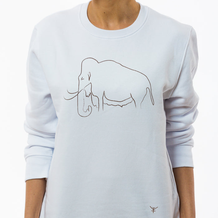 A female model wearing a white unisex sweatshirt made of quality cotton with a minimalistic print of a mammoth and a little Yulunga brand logo  on the front.