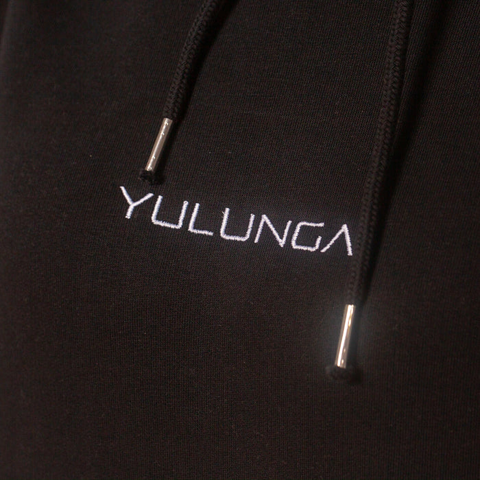 A close up on a black sustainable hoodie with a white Yulunga brand logo embroidery