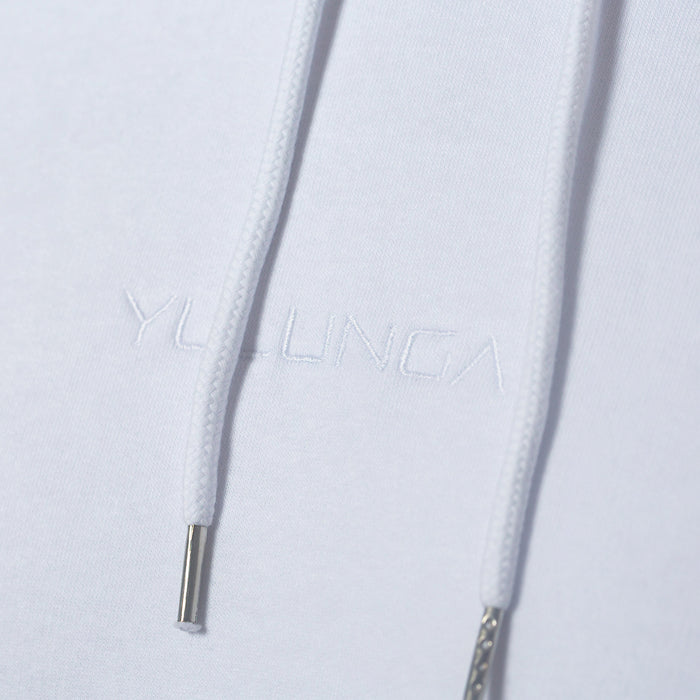 A close up on white Yulunga brand logo embroidery on an organic cotton white hoodie.