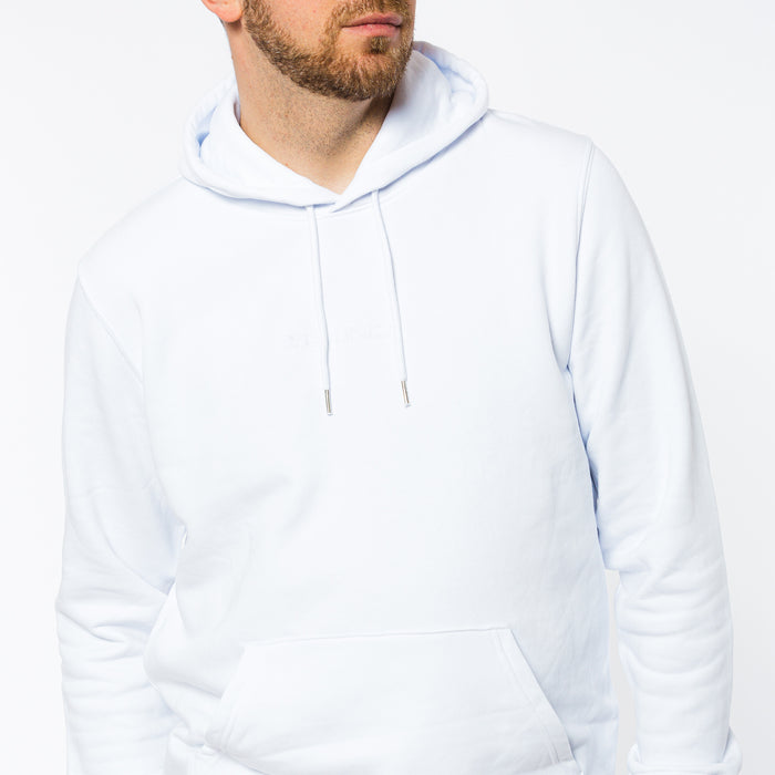 A male wearing a white organic cotton hoodie with a white embroidered Yulunga brand logo