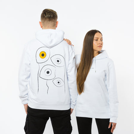 A female and a male wearing a white hoodie with a large artistic image of eyes in black and white and one yellow eye on the back and a sentence ,,life. is. art" on the front.